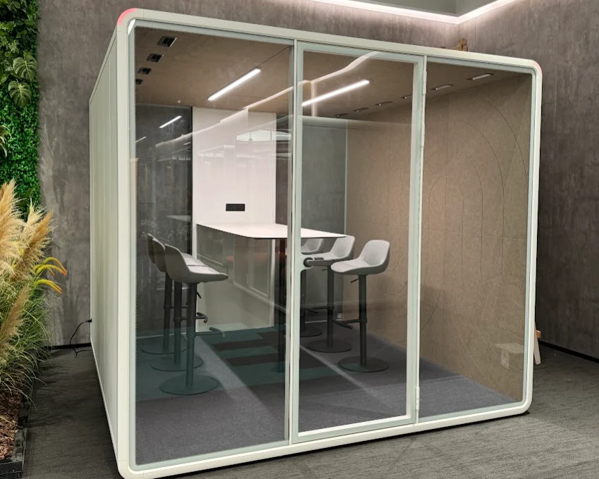 Glazed XL Pod with high tables, in front of a green wall